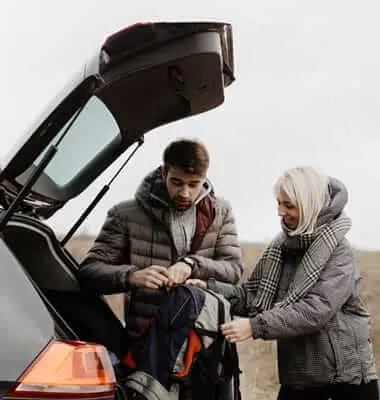 Couple loading luggage into a rental car